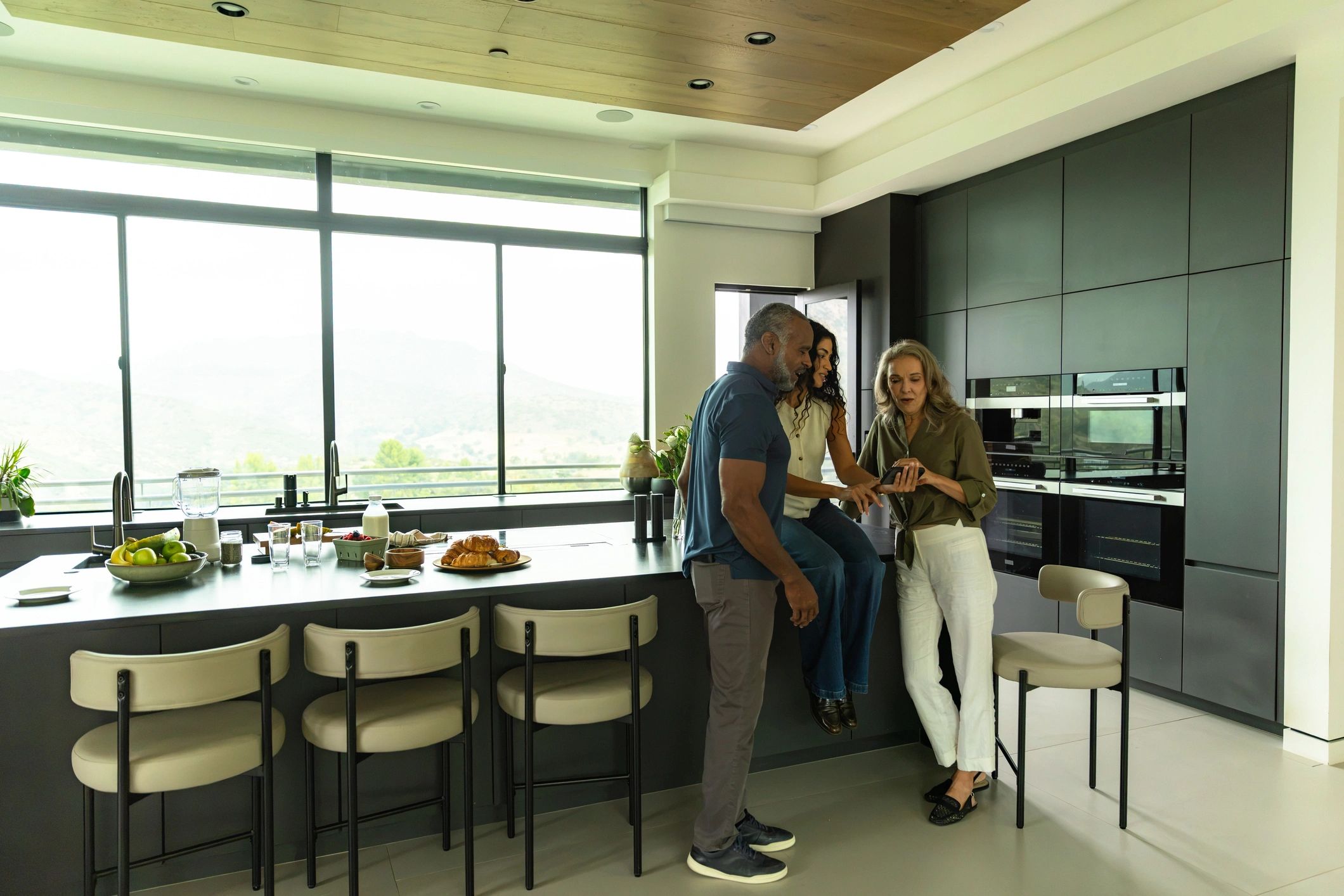 Black family gathered together in a bright kitchen